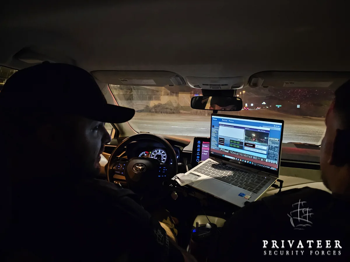 Privateer personnel using a laptop with Full Sail software inside a patrol vehicle