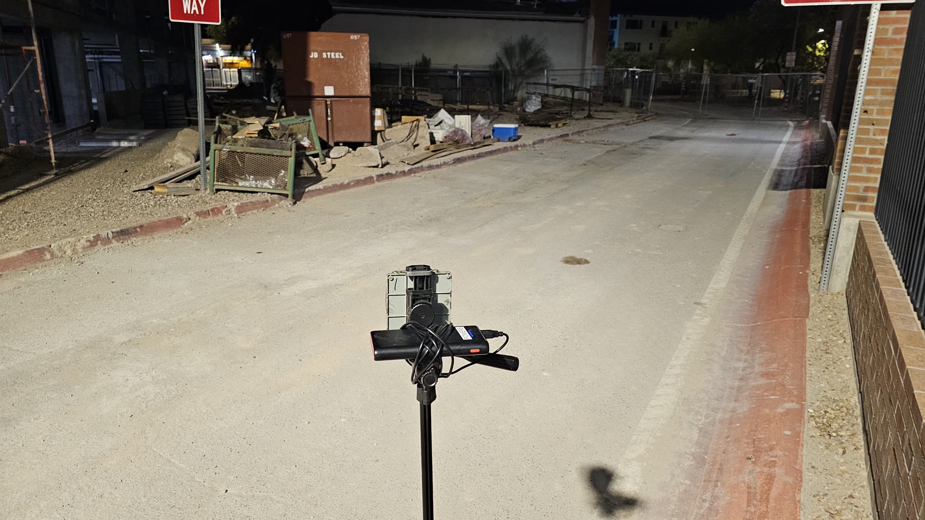 Privateer-developed camouflaged motion sensor on a temporary stand beside the Ari on Fourth construction perimeter at night