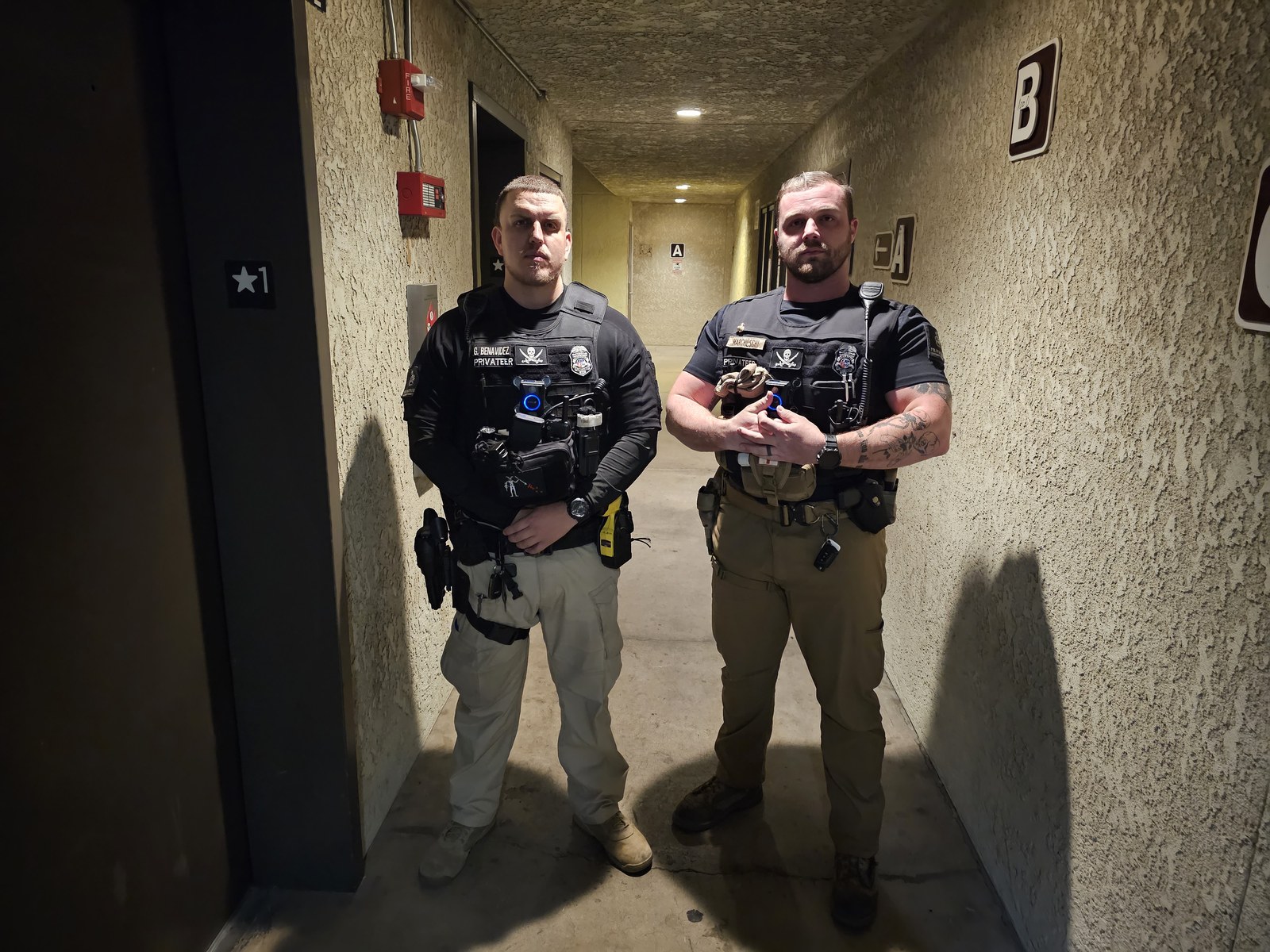 Two equipped Privateer officers with visible protective vests, body cameras and radios