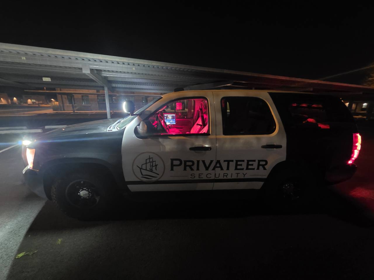 Privateer patrol SUV at night with its branded doors and illuminated cabin