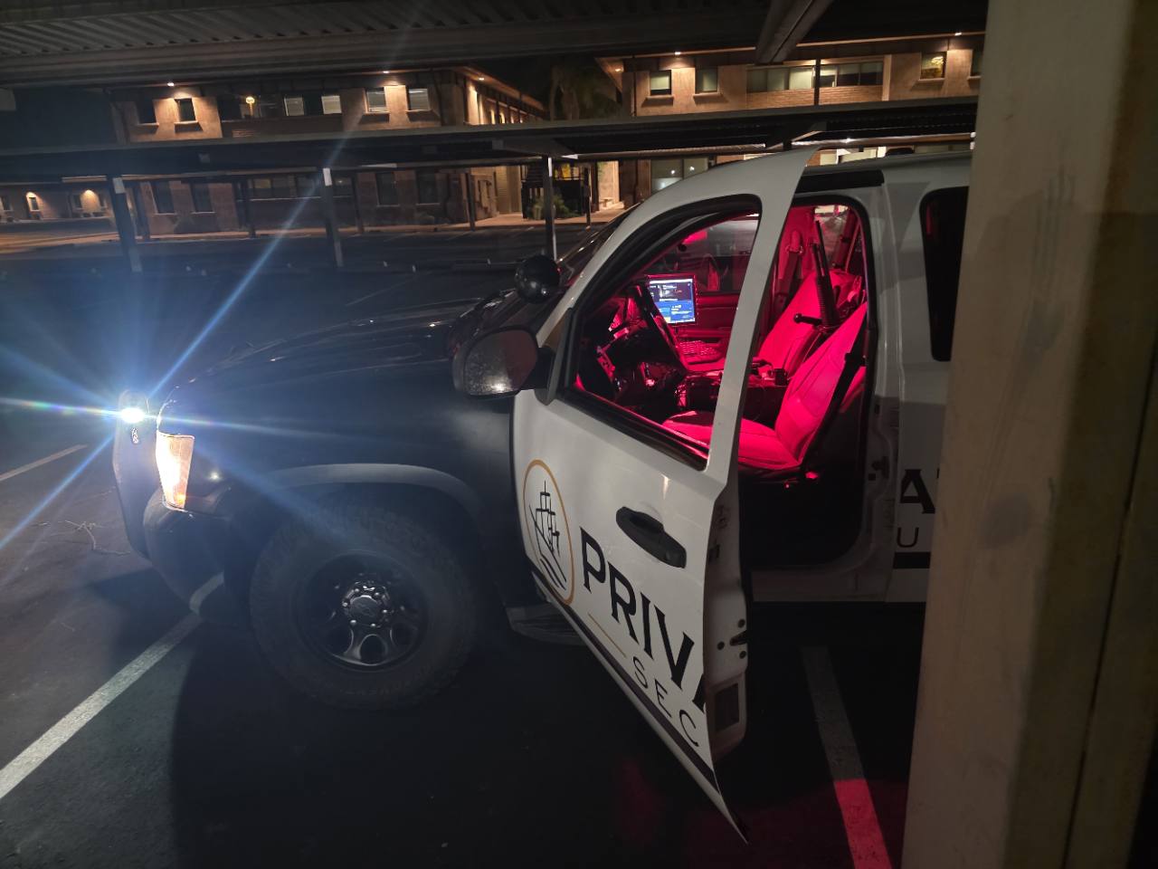 Open driver door of a Privateer patrol SUV showing a red-lit cabin and mounted computer